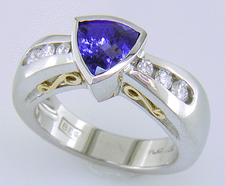 Channel set diamonds in trillium tanzanite platinum ring.