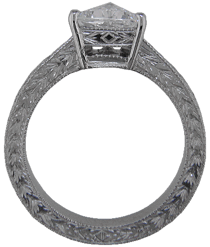 Side view of trilliant diamond platinum hand engraved ring.