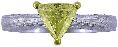 Trilliant yellow diamond set in a hand-engraved platinum ring.