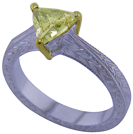 Trilliant yellow diamond set in a hand-engraved platinum ring.