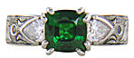 A cushion-cut Tsavorite garnet set in a beautifully hand crafted and engraved platinum ring.