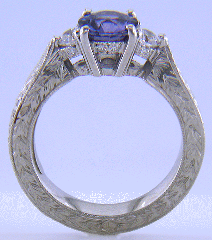 Side view of hand-engraved platinum ring with violet sapphire and diamonds.