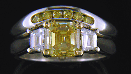 Vivid yellow emerald-cut diamond ring with contoured band.