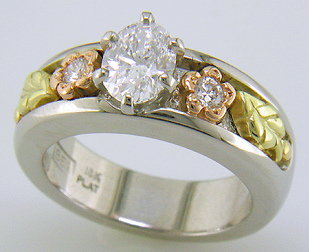 Custom platinum engagement ring with rose and green gold accents