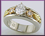 Custom platinum engagement ring with rose and green gold accents.