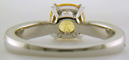 Inside view of concave faceted yellow sapphire set with two hidden diamonds in a hand-crafted platinum ring.