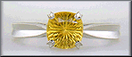 Concave faceted yellow sapphire set with two hidden diamonds in a hand-crafted platinum ring.