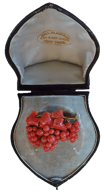 Ox-blood coral brooch in original box. (J3042)