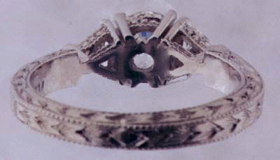 Inside view of engraved platinum ring with diamonds.