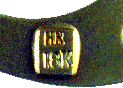 Close-up of maker's and gold marks.