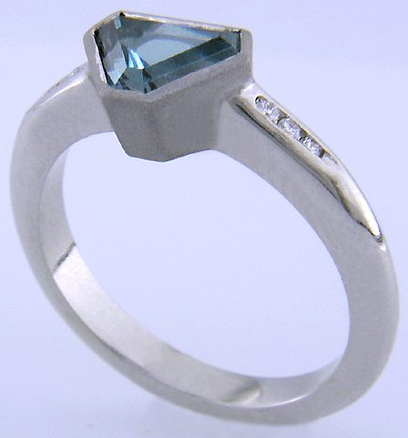 Calf-head Aquamarine with round diamonds in a custom platinum ring.