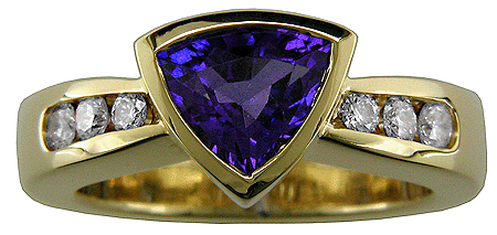 Trillium-cut tanzanite set with graduated diamonds in an 18kt gold ring.