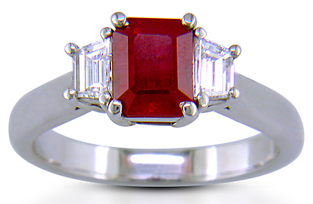 A fiery red ruby set with two trapezoid-cut diamonds in a handcrafted platinum ring. (J6405)