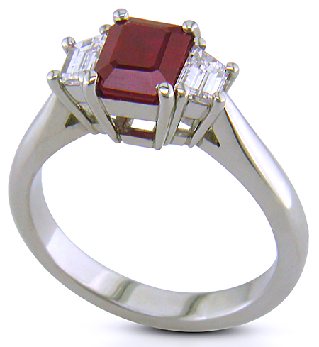 A fiery red ruby set with two trapezoid-cut diamonds in a handcrafted platinum ring. (J6405)