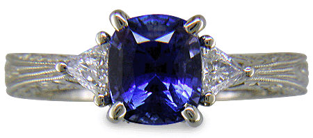 Cushion Sapphire ring with trilliant diamond and hand engraved platinum. (J8750)