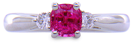 Cushion-cut Pink Sapphire set with two round diamonds in a handcrafted platinum ring. (J8597)