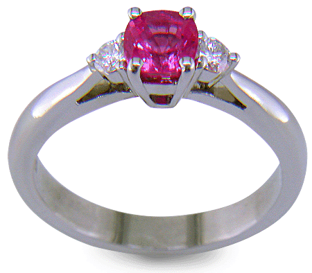 Cushion-cut Pink Sapphire set with two round diamonds in a handcrafted platinum ring. (J8597)