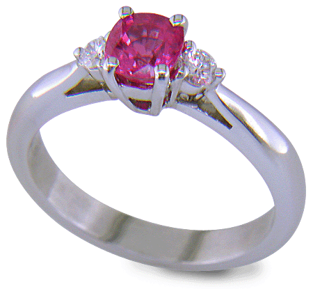 Cushion-cut Pink Sapphire set with two round diamonds in a handcrafted platinum ring. (J8597)