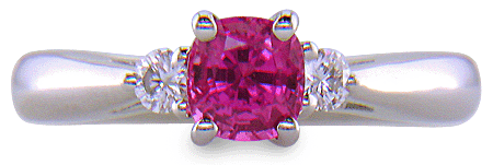 Cushion-cut Pink Sapphire set with two round diamonds in a handcrafted platinum ring. (J8597)