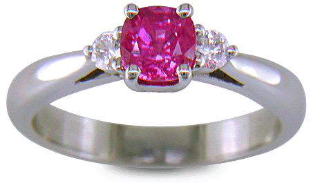 Cushion-cut Pink Sapphire set with two round diamonds in a handcrafted platinum ring. (J8597)