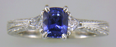 Cushion-cut sapphire and trilliant diamond hand-engraved platinum ring. (J8415)