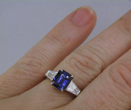 Emerald-cut Sapphire with tapered baguette diamonds in a custom platinum ring. (J8643)