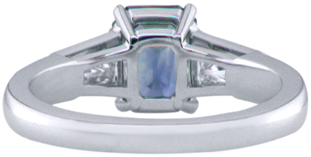 Emerald-cut Sapphire with tapered baguette diamonds in a custom platinum ring. (J8643)