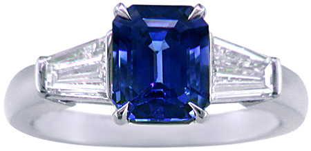 Emerald-cut Sapphire with tapered baguette diamonds in a custom platinum ring. (J8643)