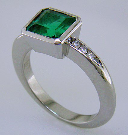 1.6-carat emerald set with round brilliant-cut diamonds in a custom platinum ring.