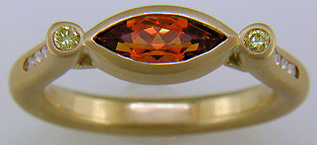 Hand-crafted 18kt gold ring with a Spessartite garnet and diamonds. (J6421)