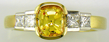 Fancy yellow sapphire ring with princess cut diamonds.