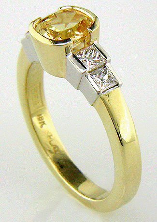 Fancy yellow sapphire ring with princess cut diamonds.