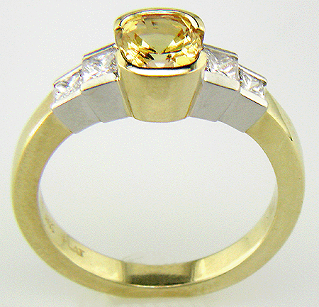 Fancy yellow sapphire ring with princess cut diamonds.