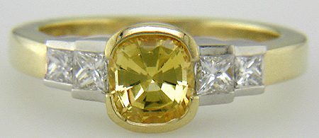 Fancy yellow sapphire ring with princess cut diamonds.