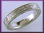 Hand engraved platinum band set with yellow diamonds.