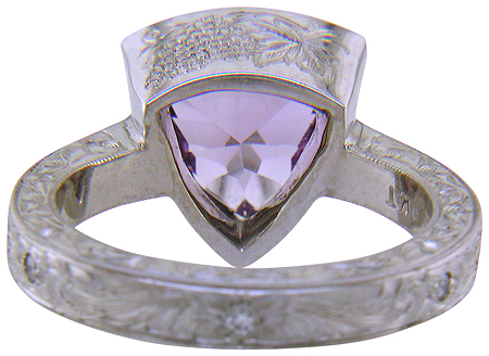 Concave-faceted Amethyst set in an engraved platinum ring. (J7415)