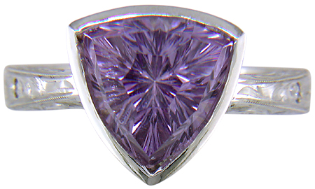 Concave-faceted Amethyst set in an engraved platinum ring. (J7415)