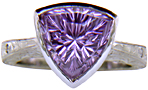 Concave-faceted Amethyst set in an engraved platinum ring. (J7415)