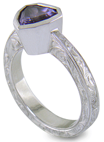 Hand engraved platinum ring with a shield-shape Lavender Spinel. (J8710)