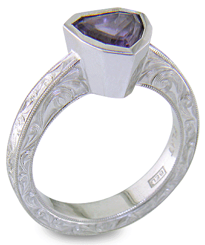 Hand engraved platinum ring with a shield-shape Lavender Spinel. (J8710)