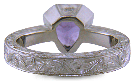 Hand engraved platinum ring with a shield-shape Lavender Spinel. (J8710)