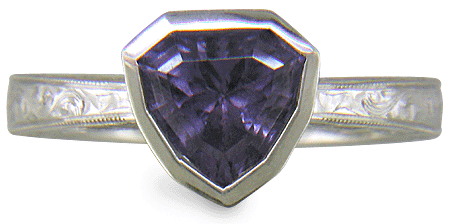 Hand engraved platinum ring with a shield-shape Lavender Spinel. (J8710)