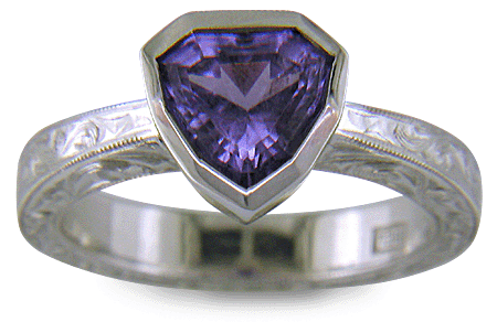 Hand engraved platinum ring with a shield-shape Lavender Spinel. (J8710)