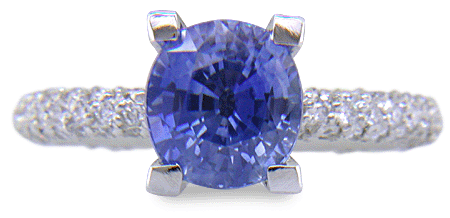 Sapphire set with pave diamonds in a platinum ring. (J8426)