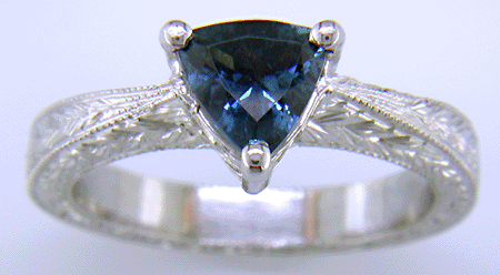 Platinum engraved ring with trillium Montana sapphire.
