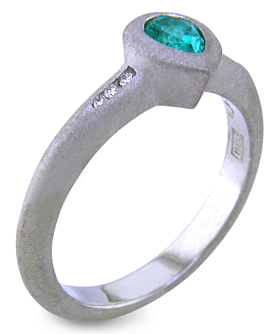 Pear-shape Paraiba tourmaline accented with diamonds in a custom platinum ring.