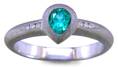 Pear-shape Paraiba tourmaline accented with diamonds in a custom platinum ring.