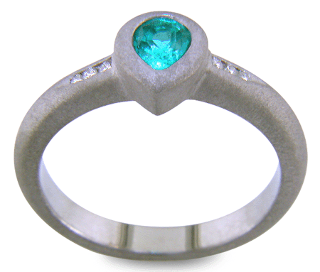 Pear-shape Paraiba tourmaline accented with diamonds in a custom platinum ring.