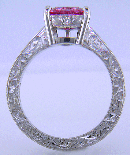 Side view of hand engraved platinum ring with a trillium pink sapphire.