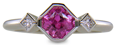 Pink Sapphire set with two Princess-cut diamonds in a platinum ring. (J8547)